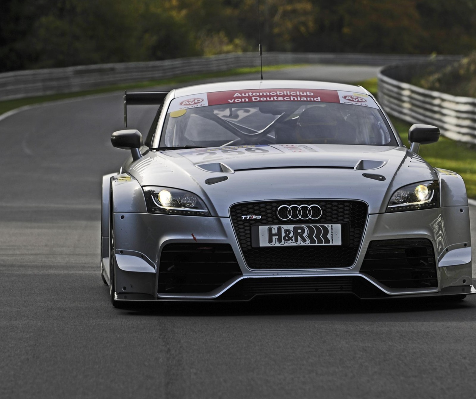 Arafed audi sports car driving on a race track with a red flag (audi, auto, car, power, racing)