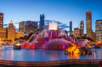 Vibrant Cityscape at Dusk Featuring Iconic Fountain and Skyscrapers