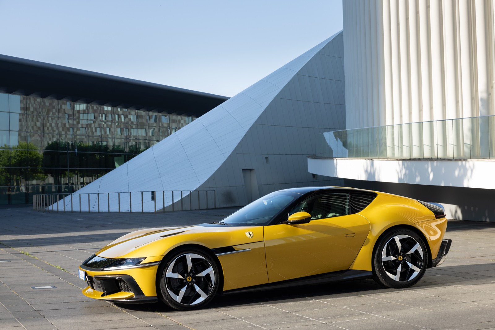 Um carro esportivo amarelo estacionado em frente a um prédio (ferrari 12 cilindros, ao ar livre, carros amarelos, 5k, 8k)