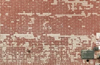 Weathered Brick Wall with Textured Pattern and Faded Paint