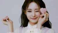 Tzuyu from TWICE Playfully Showcasing a Heart-Shaped Treat