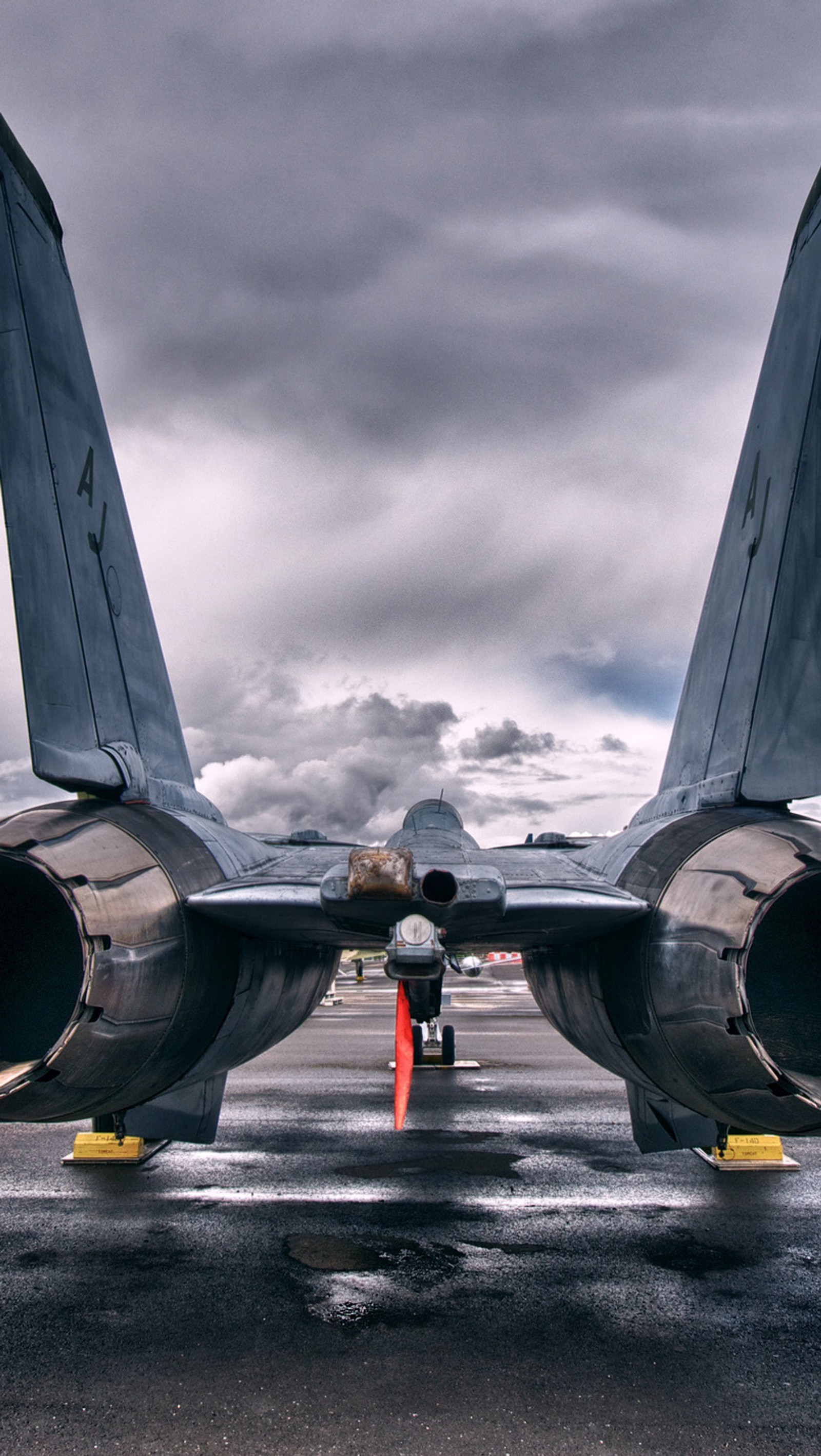 There is a large jet that is sitting on the runway (grey, plane, sky)