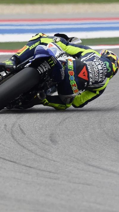 Valentino Rossi en action lors d'une course de MotoGP, montrant un virage habile sur sa moto.