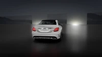 Sleek white Mercedes-Benz M-Class showcasing modern automotive lighting in an elegant urban setting.