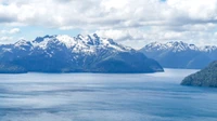 Paysage de fjord majestueux avec des montagnes enneigées et un lac glaciaire calme