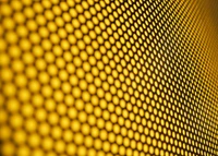 Close-Up of a Honeycomb Pattern in Vibrant Yellow and Amber Tones