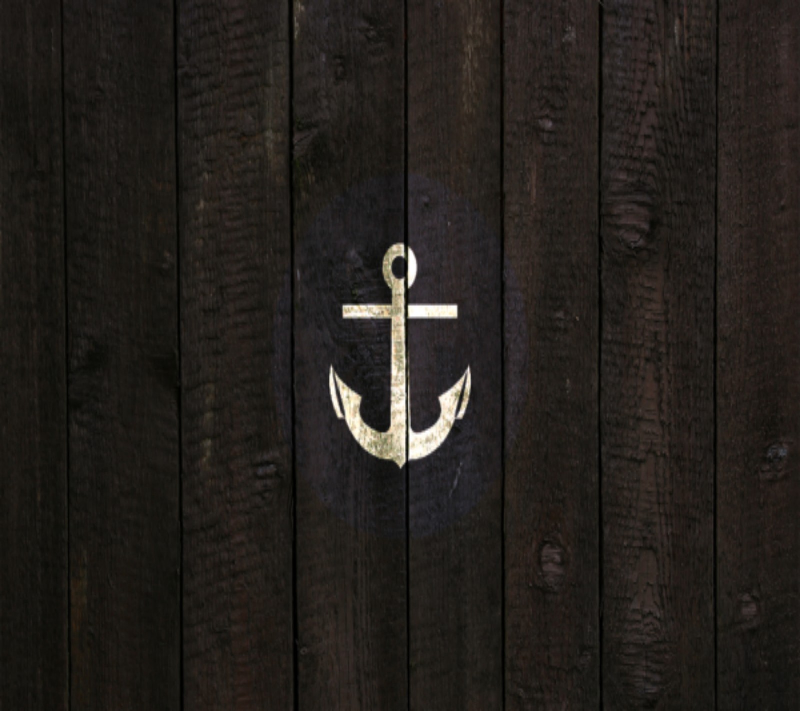 There is a wooden fence with a white anchor on it (anchor, sleeping with sirens)