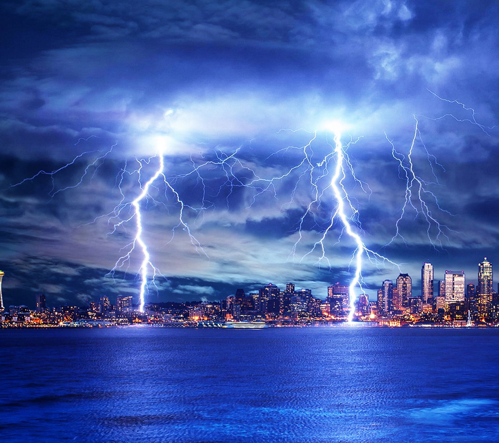 Lightning strikes over a city skyline at night time (blue, city, lightning, nature)