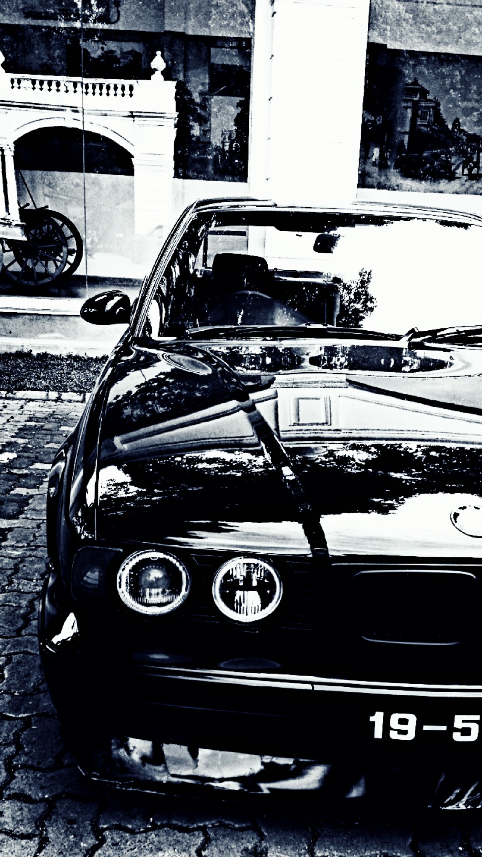 There is a black and white photo of a car parked on the street (anime, auto)