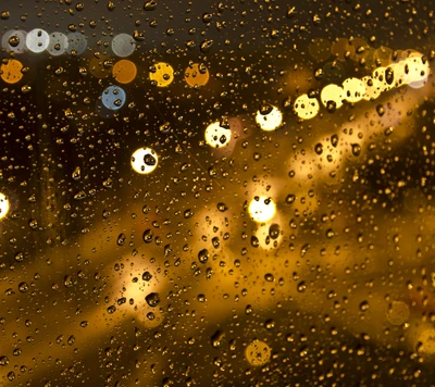 Gotas de chuva no vidro com luzes da cidade em bokeh