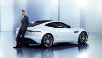 David Beckham posant à côté d'une élégante Jaguar F-Type supercar blanche, dégageant luxe et style lors d'un salon automobile.