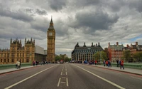 Big Ben and the Palace of Westminster under a cloudy sky, bustling with tourists on the road.