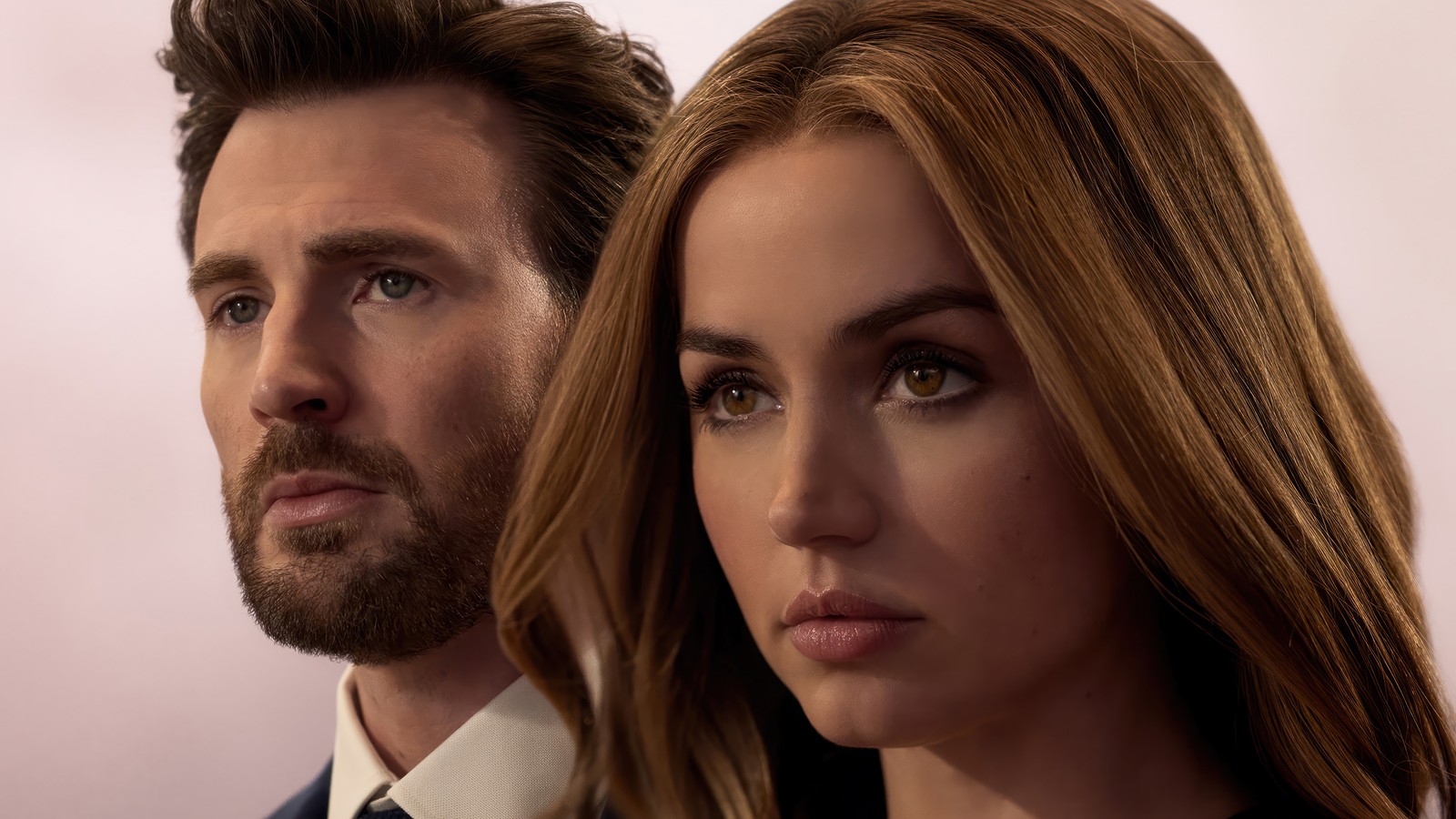 Una imagen editada de un hombre y una mujer mirando a la cámara (ghosted 2023, 2023, película, chris evans, ana de armas)