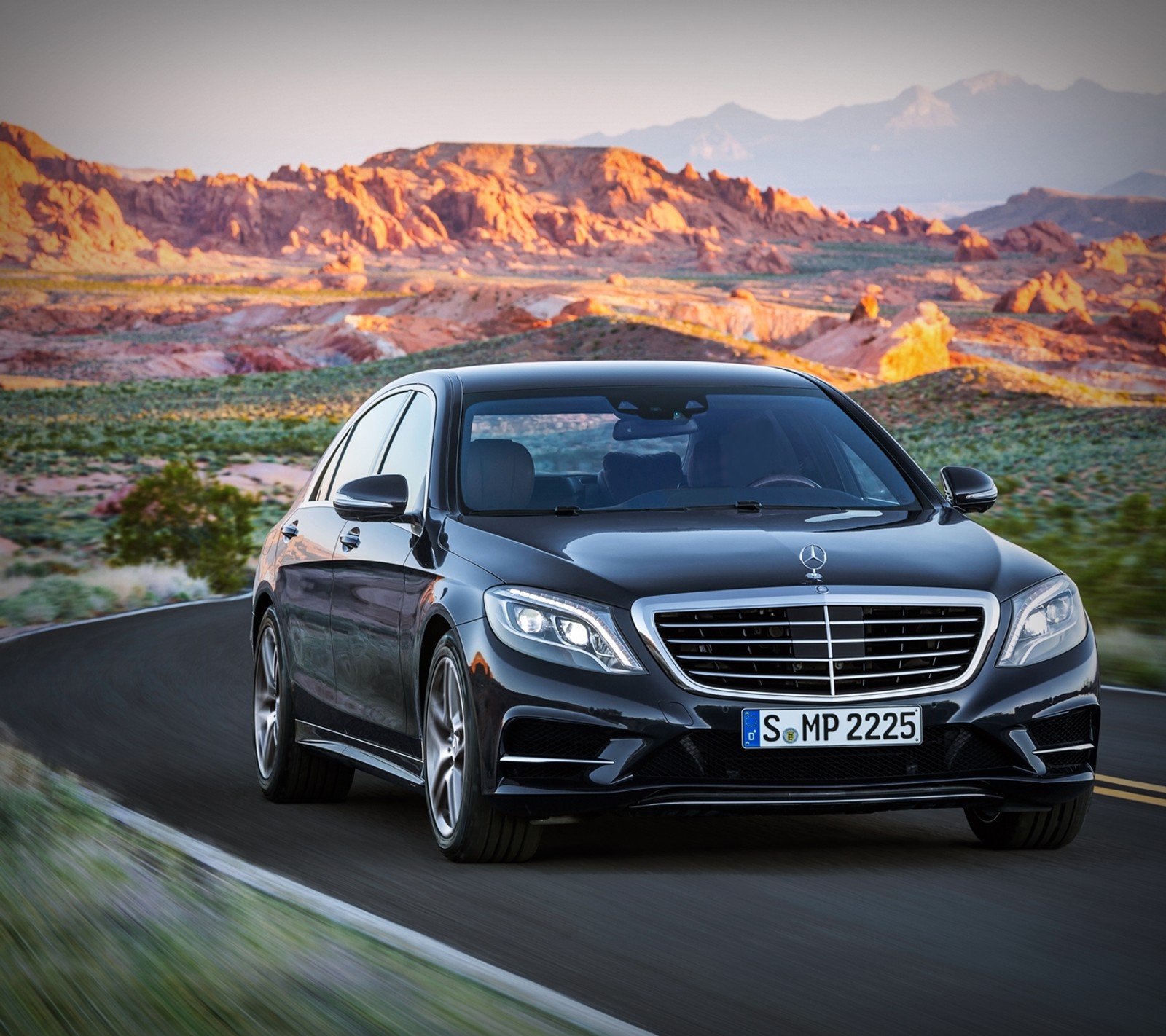 A black mercedes s - class driving down a road in the desert (benz, car, mb, merc, mercedes)