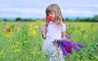 Criança em um prado cercada por flores silvestres