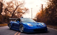 Modifizierter blauer Honda NSX: Ein atemberaubendes Sportauto auf einer malerischen Straße.