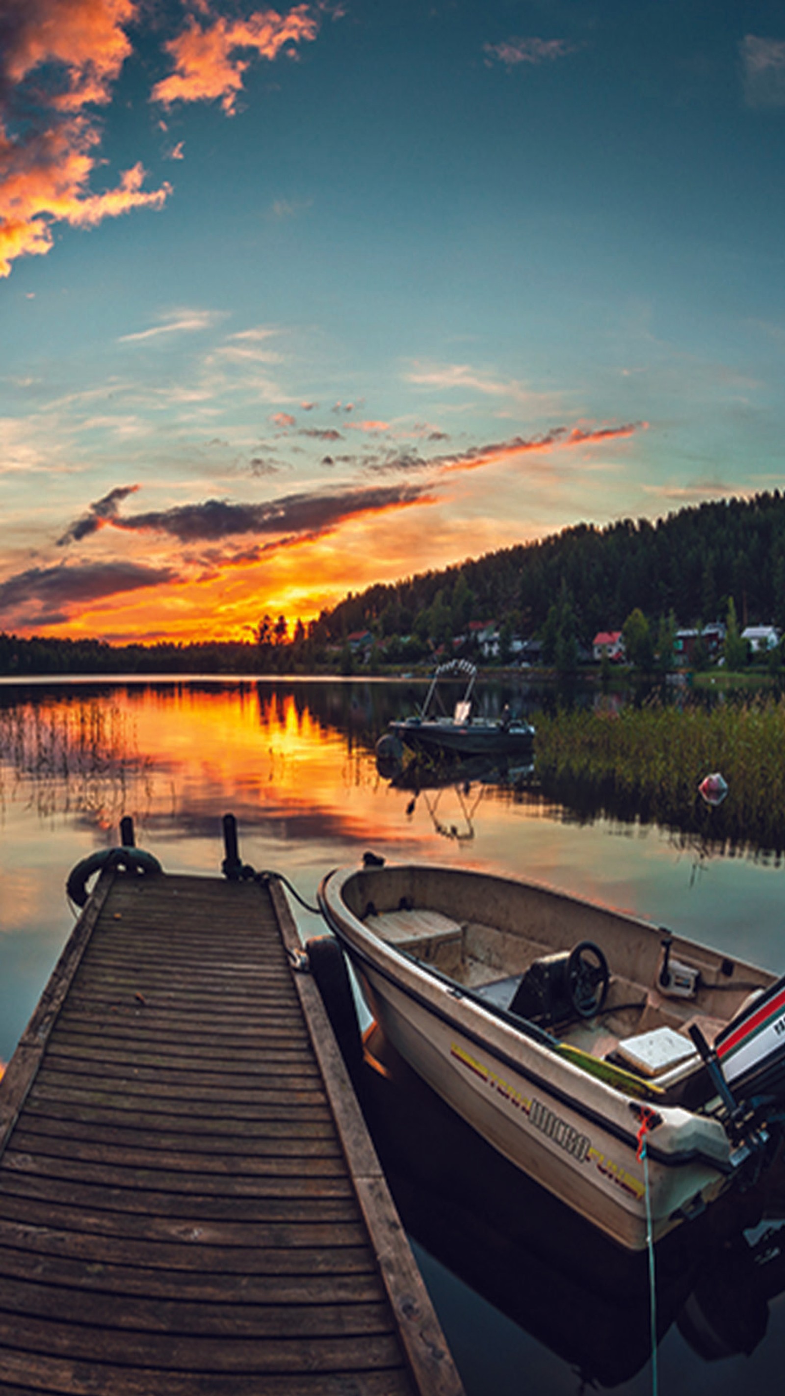 Boats docked on a dock at a lake at sunset (bank, lake)