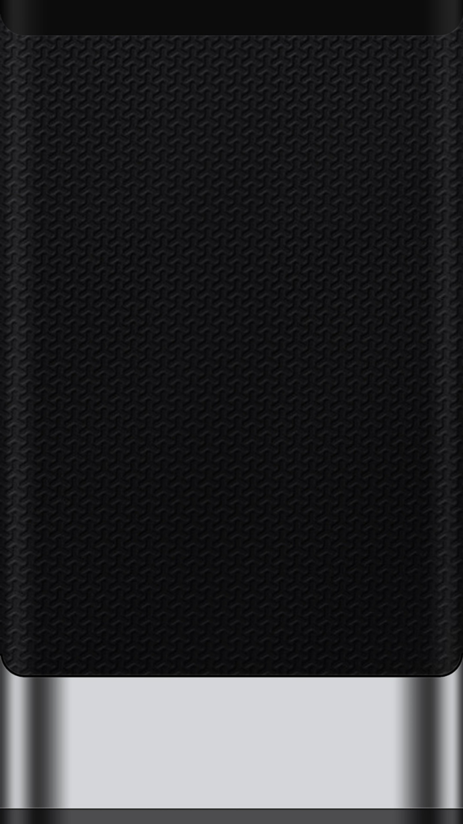 A close up of a black cell phone with a silver trim (black, edge, edge style, grey, metal)