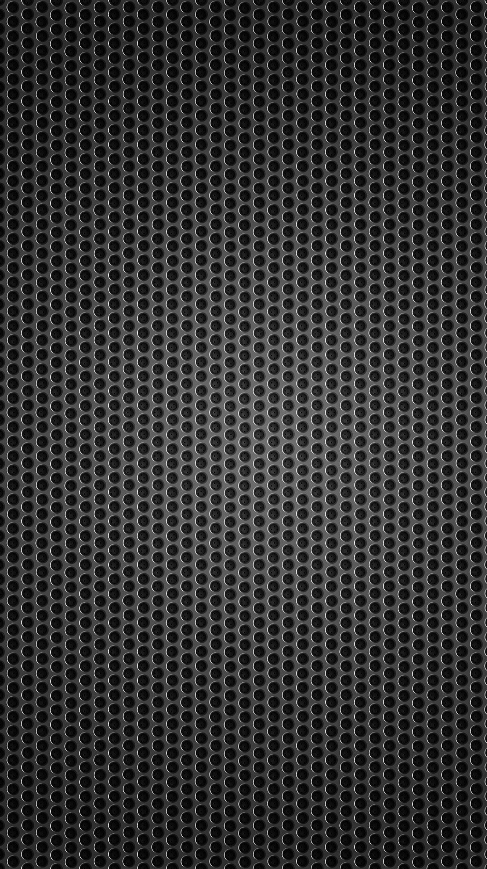 A black and white background with a pattern of circles (black, dots, metallic)