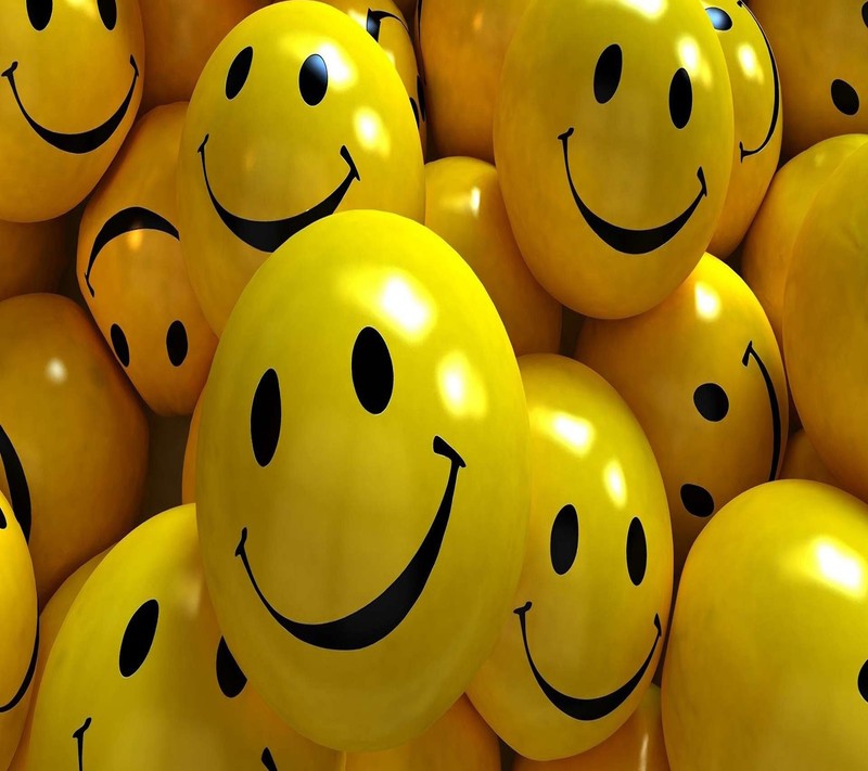 Yellow balloons with smiley faces are piled together in a pile (look, nice)