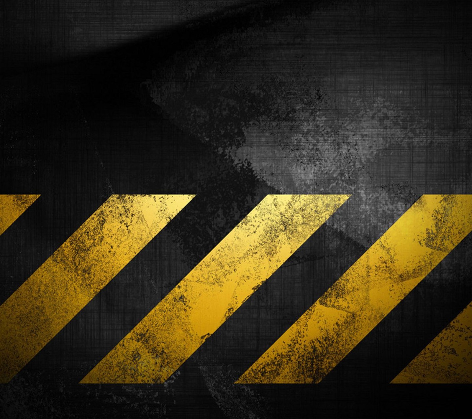 A close up of a black and yellow hazard hazard stripe (caution, hazard, sign, strips, yellow)