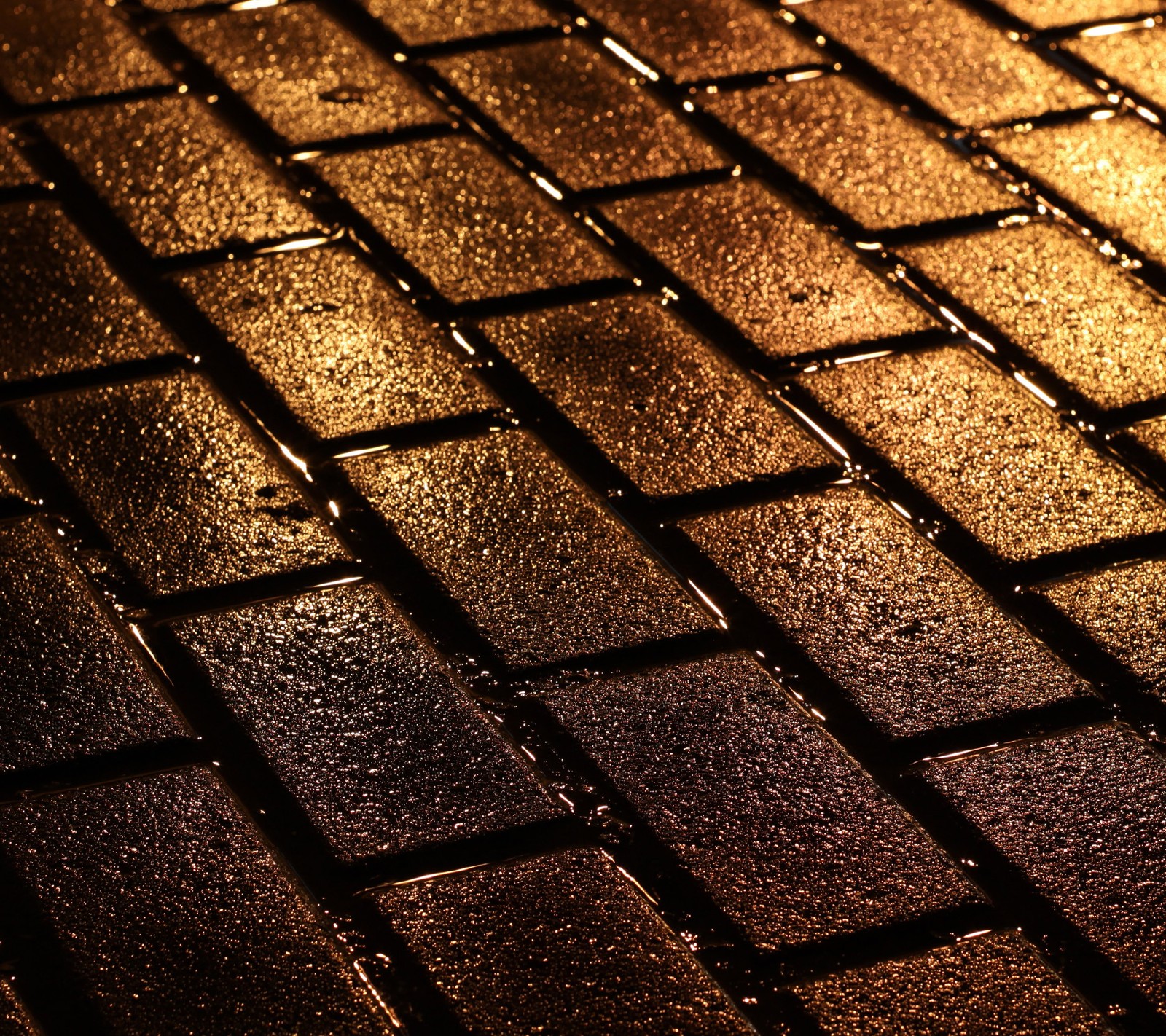 A close up of a brick sidewalk with a light shining on it (brick road, bricks, night, road, wet)