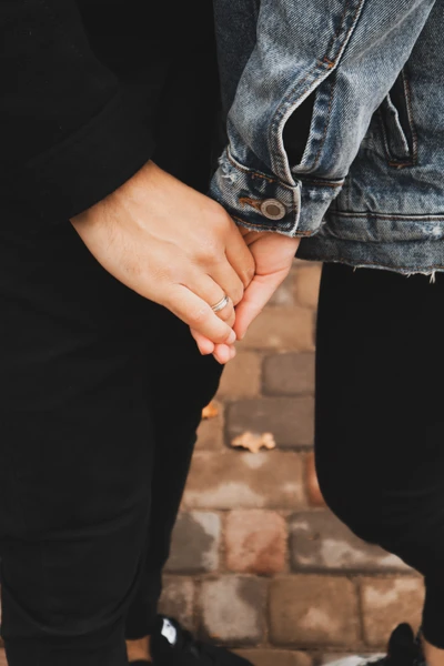 Intertwined Hands: A Gesture of Connection in Denim Fashion