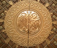 Intricate Golden Calligraphy on Ornate Wooden Door