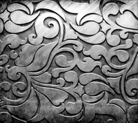 Intricate Silver Metal Plate with Decorative Swirl Pattern