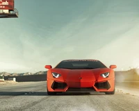 Red Lamborghini Aventador on a deserted road under a clear sky.