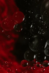 Gouttes de liquide rouge et noir dans l'espace