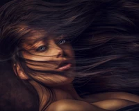 Elegant portrait of a beautiful woman with flowing hair, capturing a moment of dynamic beauty and expression.