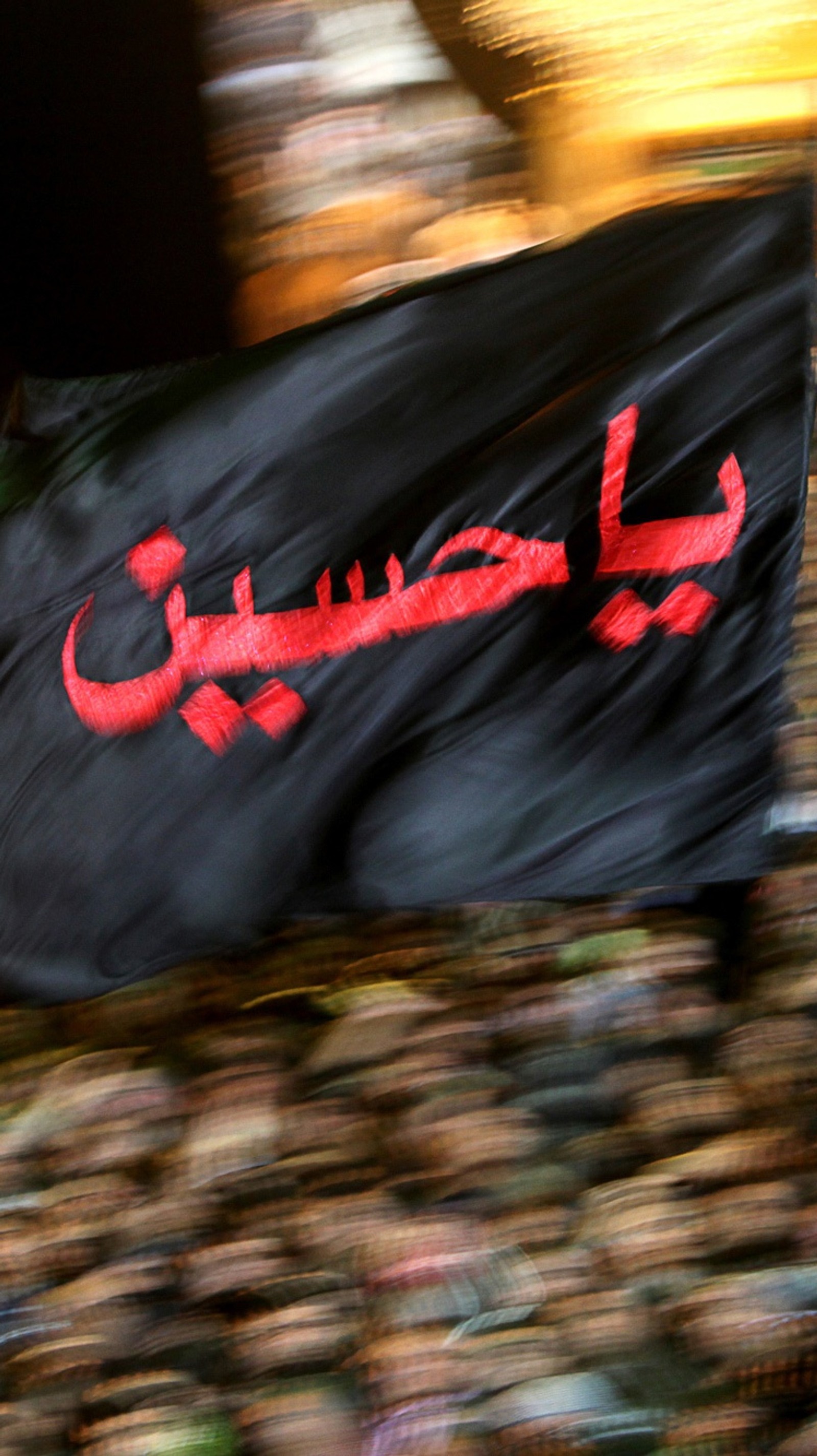 Araffe flag with arabic writing in front of a crowd of people (arab, arabs, islam, kuwait, love)