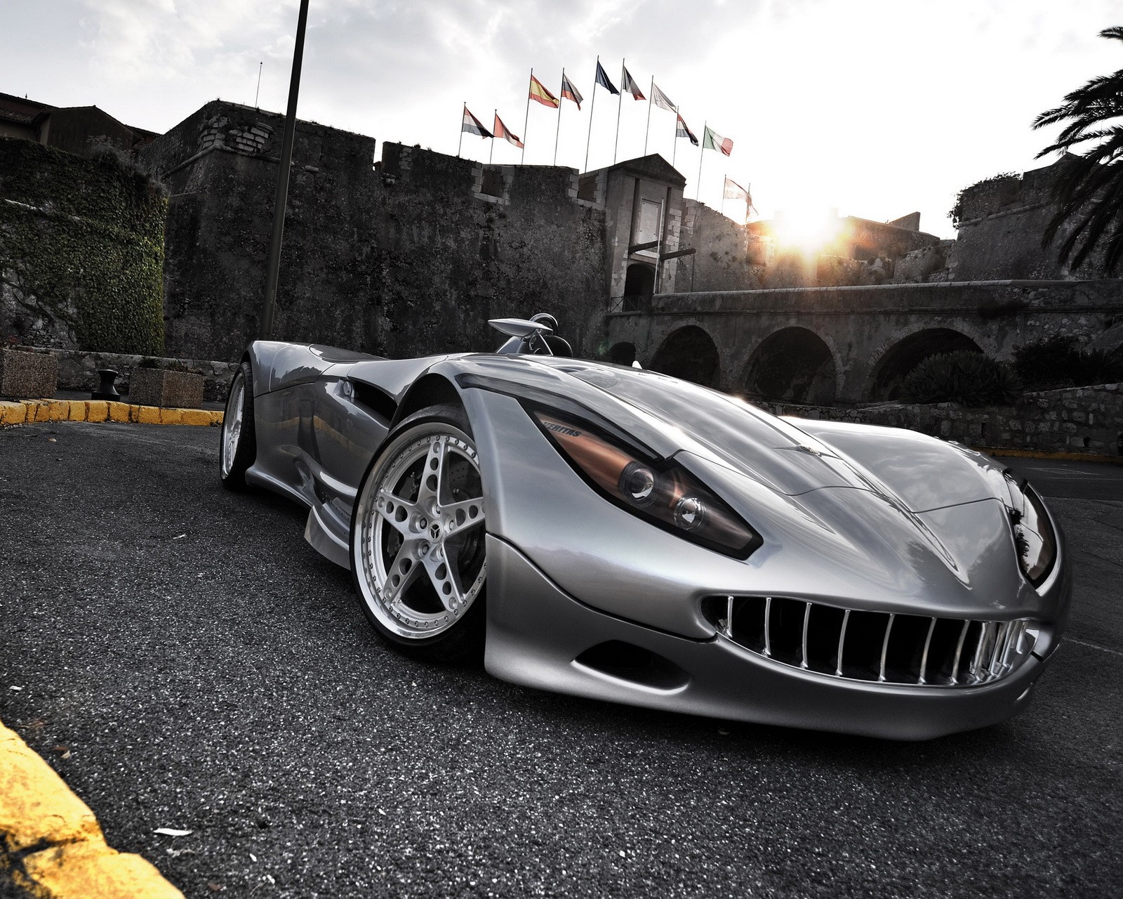 Arafed sports car parked in front of a castle with flags flying (cars, concept, f1, hd, new)