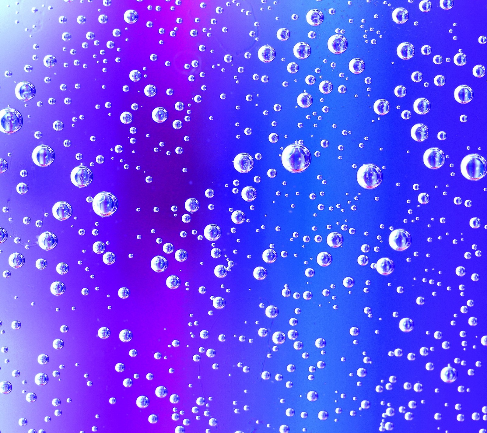 A close up of a bunch of bubbles on a glass (abstract blue, background, drops bubbles)