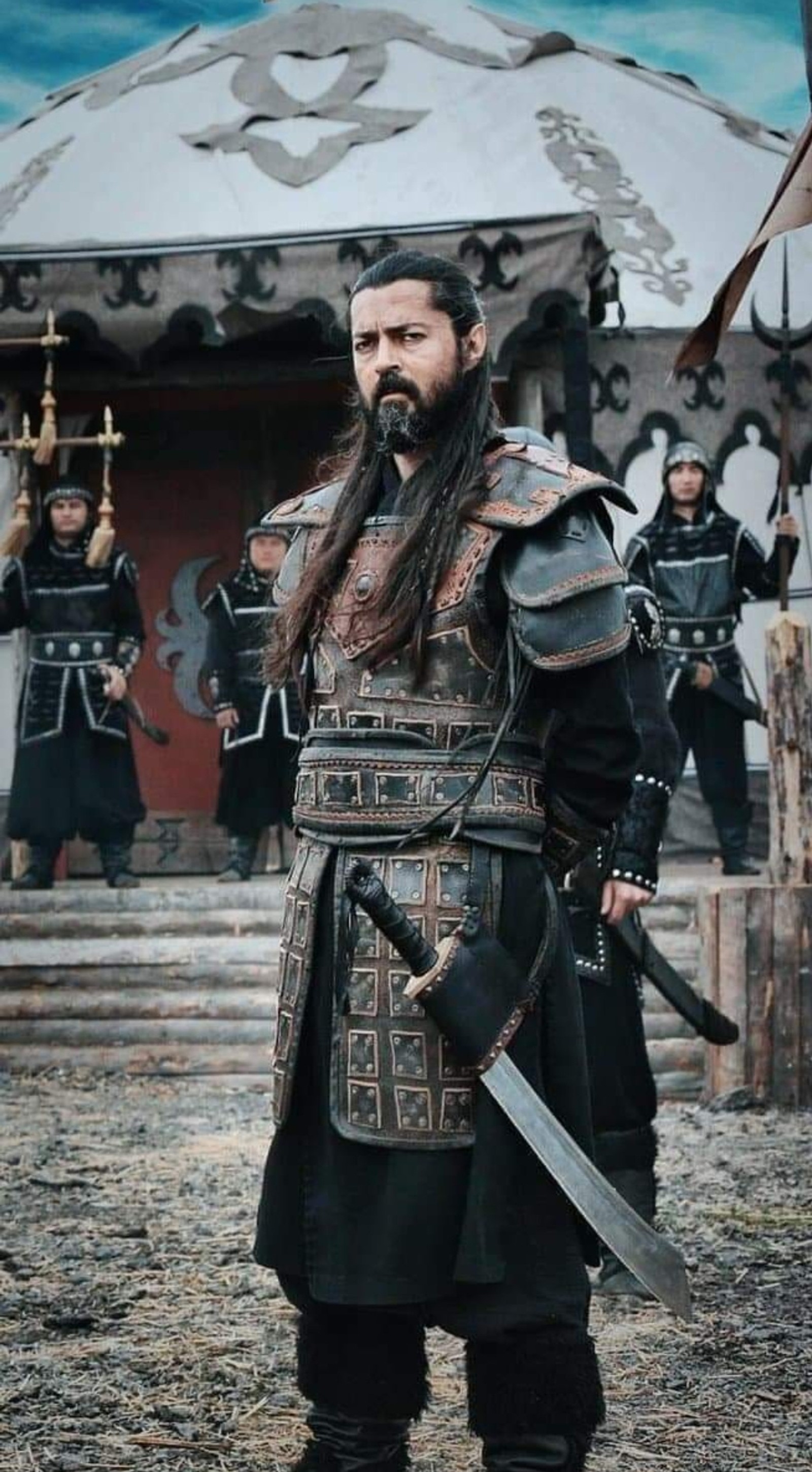 A man with long hair and a beard in a warrior outfit (ertugrul, noyan)