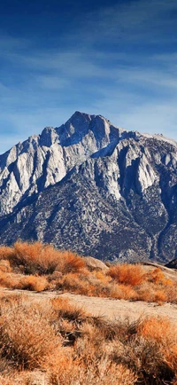 Majestic Mountain Range with Snow-Capped Peaks and Golden Highland Terrain