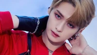 Lee Know from Stray Kids in a striking close-up, showcasing his captivating expression and stylish outfit.