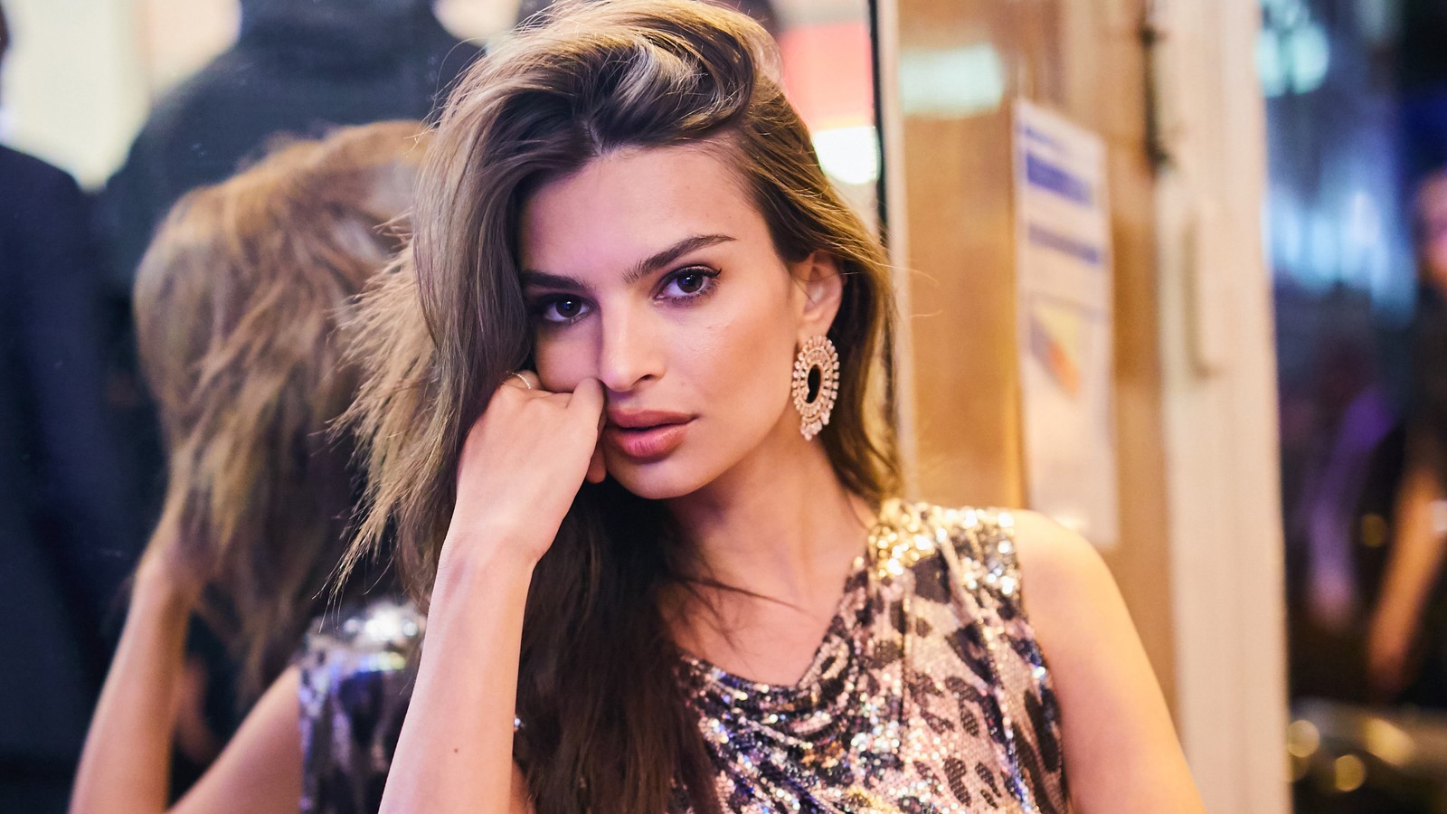 Araffe woman with long hair and earrings sitting in front of a mirror (emily ratajkowski, model, celebrity, women, girls)