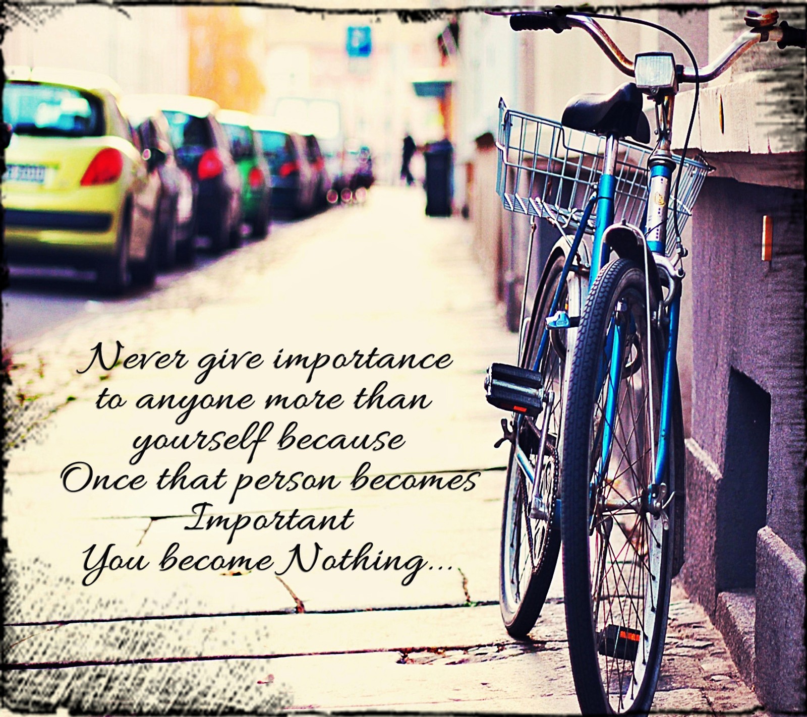 There is a bicycle parked on the sidewalk with a quote on it (alone, bicycle, feelings, hurt, importance lonely)