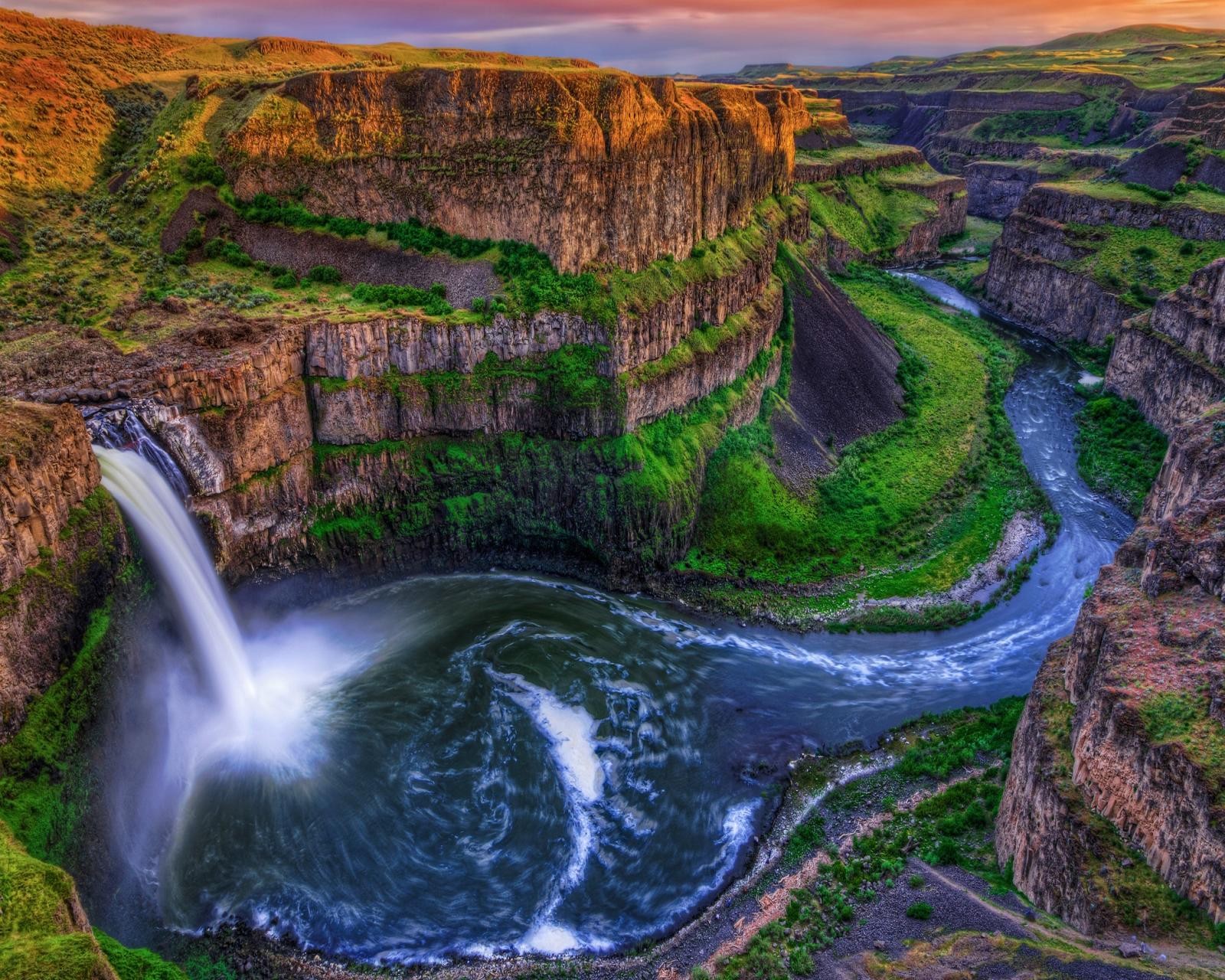 A view of a waterfall flowing through a lush green valley (hd, nature, waterfall)