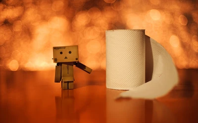 Robot Danboard avec rouleau de papier sur un fond lumineux