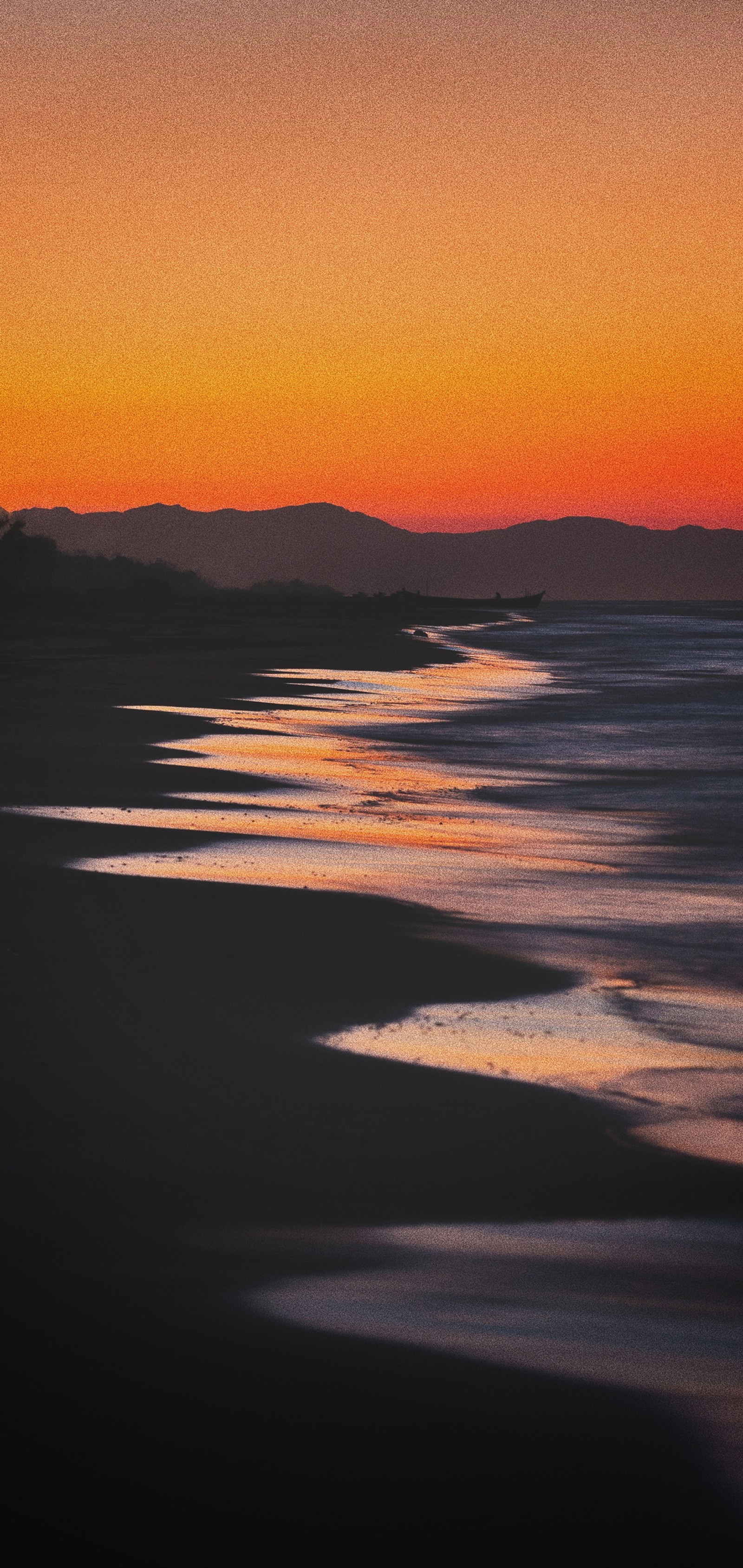 Arafed view of a beach with a sunset and a body of water (sunset, water, atmosphere, afterglow, amber)