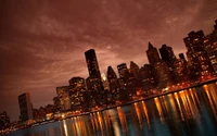 Manhattan Skyline bei Nacht: beleuchtete Wolkenkratzer und reflektierendes Wasser