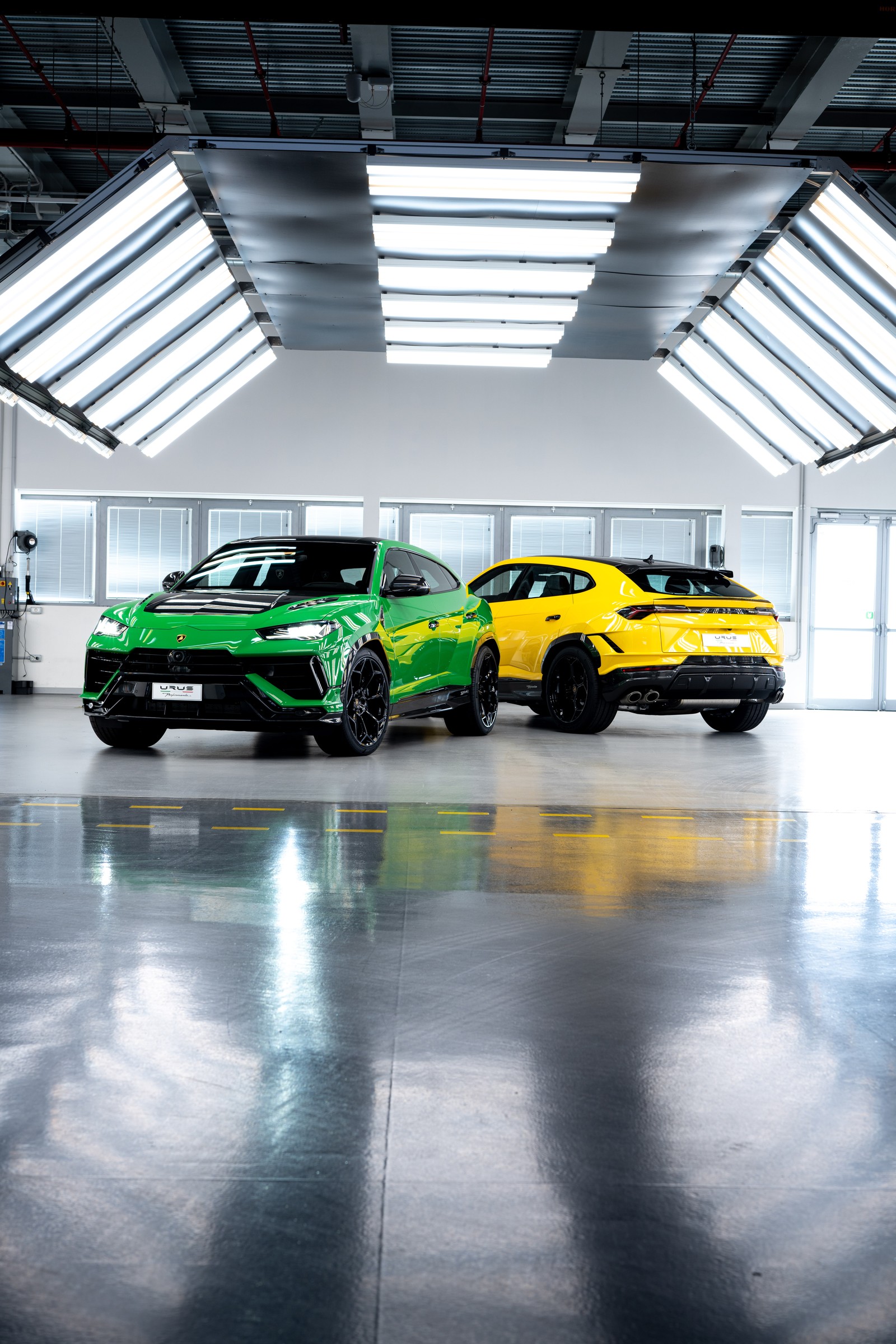 Two cars are parked in a garage with a large window (lamborghini urus performante, supercars, super suv, 2022, 5k)