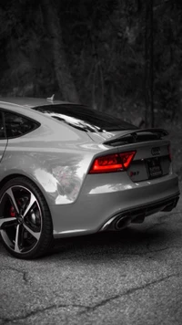 Sleek Audi sports car with striking red taillights and a refined design.