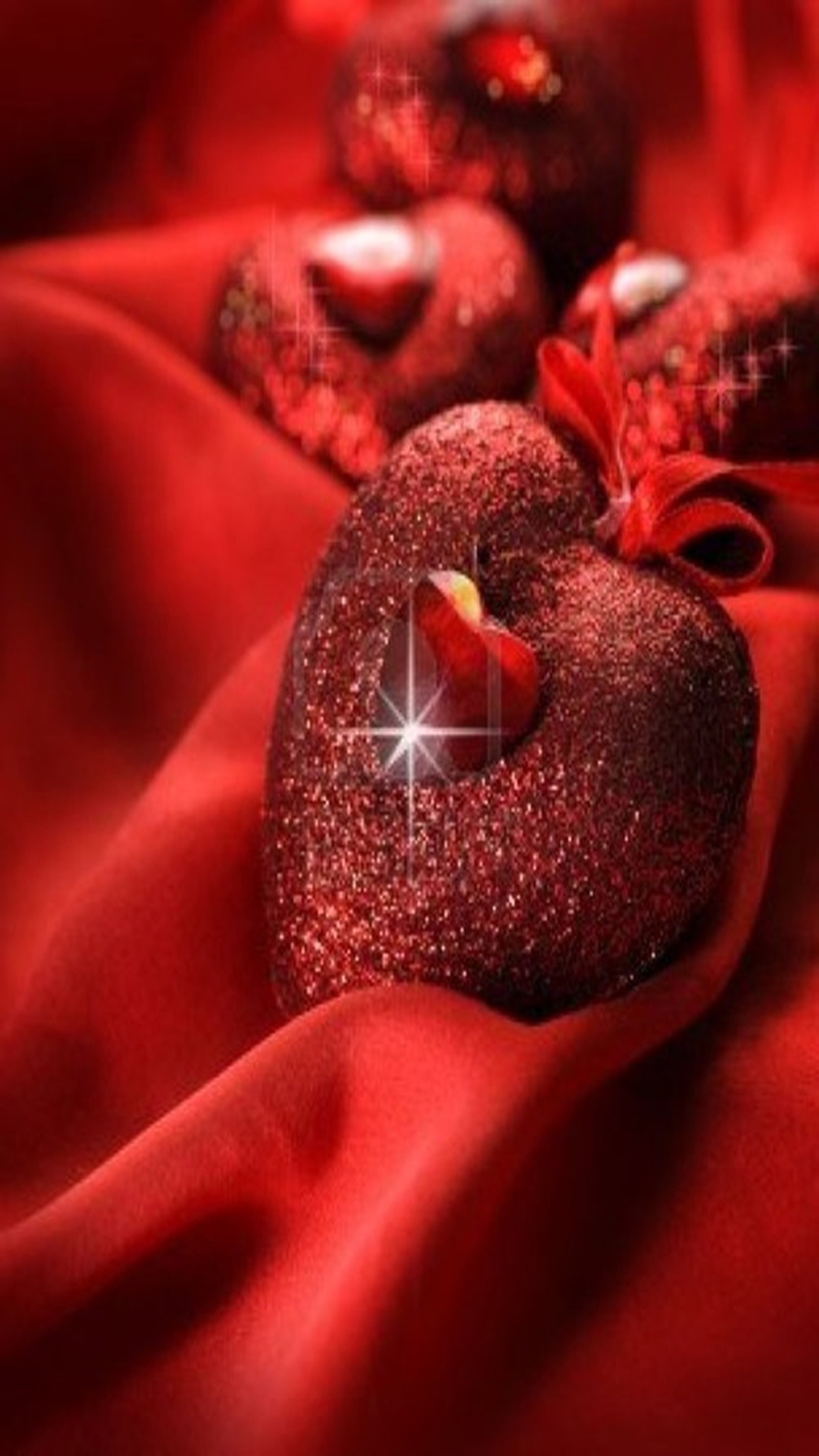 A close up of a heart shaped cookie on a red cloth (heart, love)