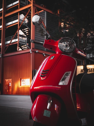 Scooter rouge classique sous les lumières nocturnes urbaines