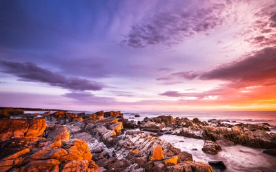 Nascer do sol sobre a costa rochosa da Baía de Fogo, Tasmânia