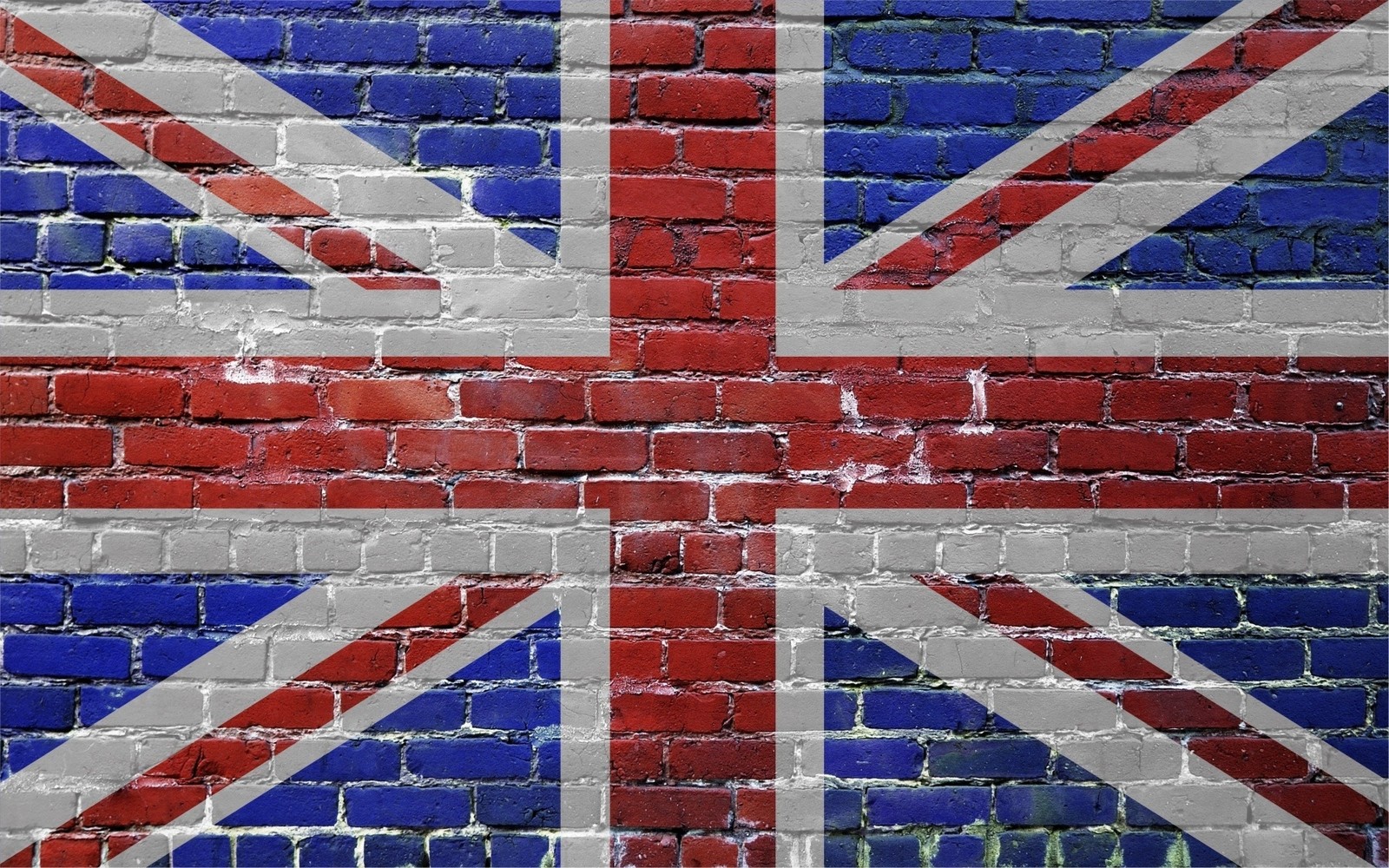 Un gros plan d'un mur en briques avec un drapeau britannique peint dessus. (maçonnerie, bleu, mur, motif, ligne)